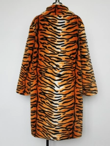 Macro detail of high-quality faux fur material with vibrant orange tiger print pattern