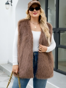 Outdoor shot of a brown faux fur longline vest styled with jeans and white top