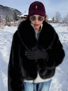 Detail of high-density black faux fur texture with wide lapel collar on winter coat