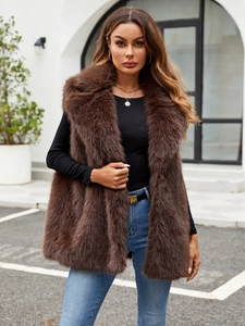 Detailed close-up of dark brown faux fox fur texture and plush long-hair vest finish
