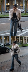 Short faux fur jacket in beige shown in a winter street style setting with snow