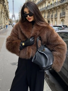 Brown faux fur jacket texture and plush material detail in a Parisian street setting
