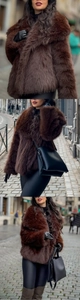 Detailed texture of thick dark brown faux fur jacket with large lapels and plush finish