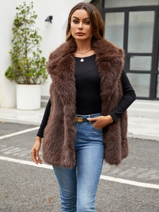 Detailed view of dark brown faux fox fur vest with thick texture and sleek lapel design