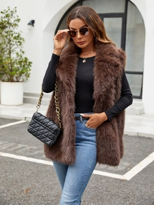 Street style view of a plush brown faux fur vest with long hair texture and soft finish