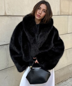 Close-up of plush faux fur texture and lapel design on this black cropped coat