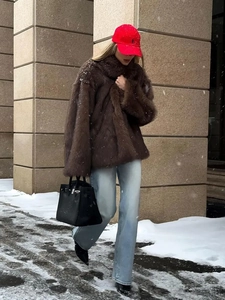 Stylish brown faux fur coat for women, perfect for winter street style and outdoor snow