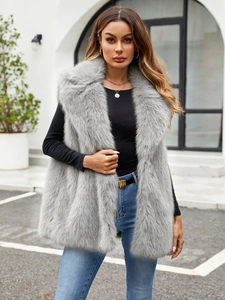 Detail shot of the plush faux fox fur texture and wide collar on a gray winter vest