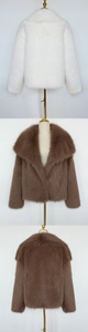 Close-up detail of white and brown faux fur jacket with large collar and plush texture