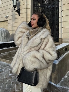 Close-up of fluffy faux fur coat lapel in light grey with thick plush texture