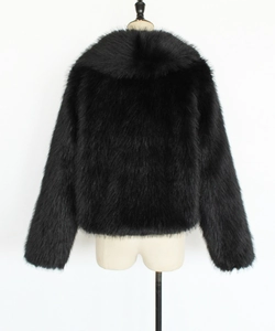 Macro detail of the thick black faux fur texture and collar on this stylish winter coat