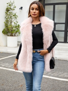 Detail of light pink faux fox fur vest with dense long fur texture and soft glossy finish