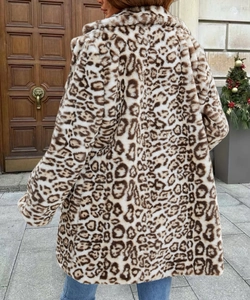 Rear view of a loose-fitting leopard print faux fur coat for women in a festive setting