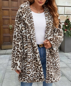 Detail view of the leopard print faux fur coat texture and its mid-length silhouette