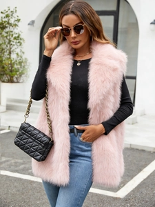 Close-up of light pink faux fox fur vest showing plush texture and sleeveless design