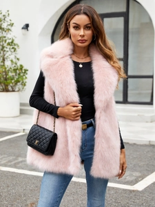 Chic pink faux fox fur vest with oversized collar styled with denim and black top