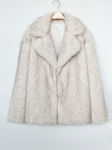 Detail of plush faux fur texture on a collared winter coat with grey-tipped cream fur