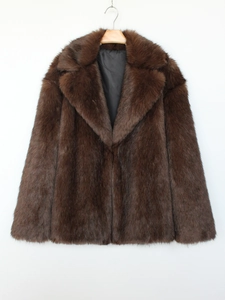 Detail of dark brown faux fur coat with wide lapel and smooth black lining texture