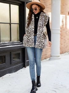Faux fur leopard print vest for women styled with casual winter outfit in outdoor setting