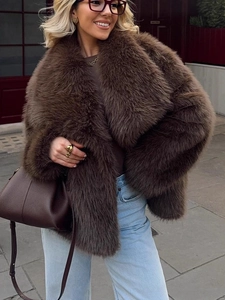 Brown faux fur jacket with oversized collar styled with jeans and a leather handbag
