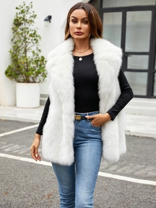 Close-up of white faux fox fur vest with plush texture and stylish wide collar
