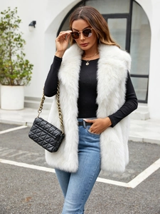 Close-up of plush white faux fox fur vest showing premium texture and fluffy collar
