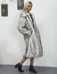 Full-length view of a long grey faux fur coat with white textures on a female model