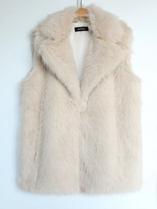 Detail view of plush beige faux fox fur texture and lapel collar on women's vest