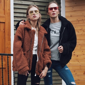 Oversized women's fleece jackets in rust red and black with zip-up collars and street style