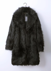 Close-up of the plush faux fur texture and large lapel collar on a black winter coat