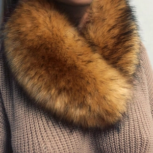Faux fox fur collar in ginger brown with a soft texture on a beige knit sweater