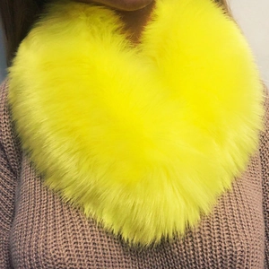 Fluorescent yellow faux fox fur collar shawl worn over a purple knitted sweater
