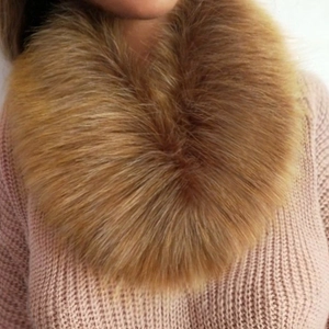 Close-up of soft brown faux fur collar paired with a pink knitted winter sweater