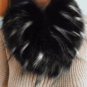 Close-up detail of luxurious black faux fox fur scarf with silver-tipped accents
