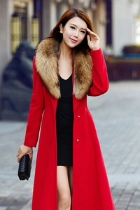 Detailed close-up of a luxury red wool coat featuring a large faux fur collar and gold buttons