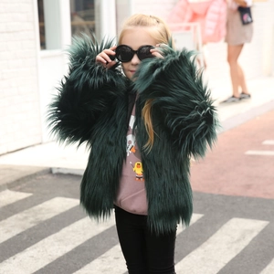 Close-up of fluffy dark green faux fur texture on a stylish long-sleeve kids winter coat