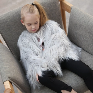 Detail of light grey faux fur jacket with fluffy long pile texture for kids