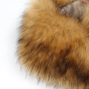 Detailed close-up showing texture of long faux fox fur stole in gradient brown and tan