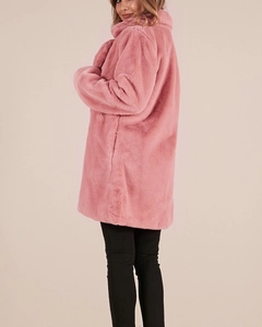 Detail view of pink faux fur coat showing soft fluffy texture and relaxed fit silhouette