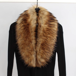 Detail of black ribbed knit top with a luxurious brown faux fur collar on a white hanger