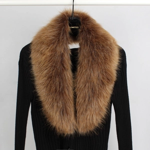 Detailed view of soft brown faux fur scarf texture on a black knitted sweater