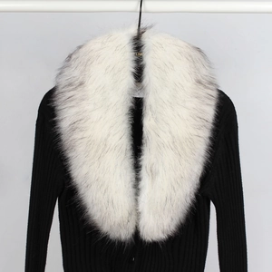 Detail of elegant black ribbed knit cardigan featuring a plush white faux fur collar accent