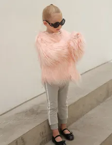 Detail of pink faux fur kid's jacket featuring long shaggy texture and round collar design