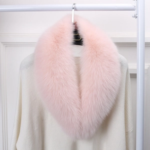 Close-up of soft pink faux fur collar with lush fluffy texture on white sweater