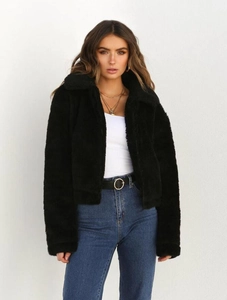 Detail of soft black faux fur jacket with lapel collar and metal zipper closure