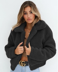 Close-up of black sherpa jacket texture with zipper closure and stand collar detail