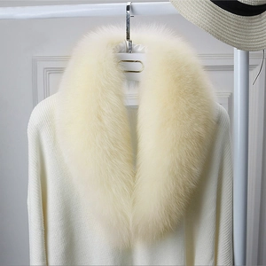 Detail of soft faux fox fur scarf in light beige on a hanger with high gloss finish