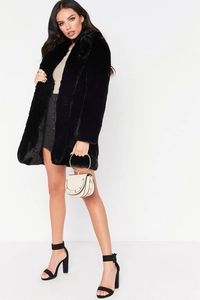 Mid-length black faux fur coat with lapel collar and stylish white ring-handle handbag