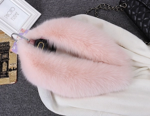 Detail of pink faux fur collar scarf with fluffy texture and metal hook closure