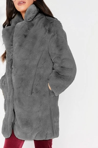 Close-up detail of grey faux fur coat featuring a soft texture and oversized lapel collar